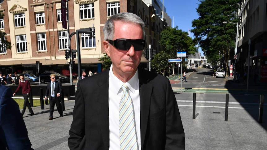 Brad Sherwin, wearing sunglasses, walks to court