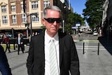 Brad Sherwin, wearing sunglasses, walks to court