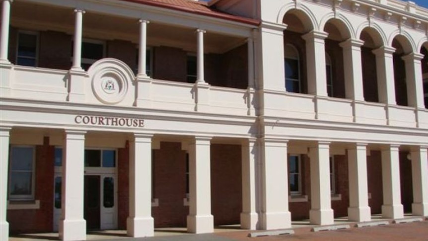 Photograph of Geraldton Courthouse building with tiled roof, arches and sign on the entrance