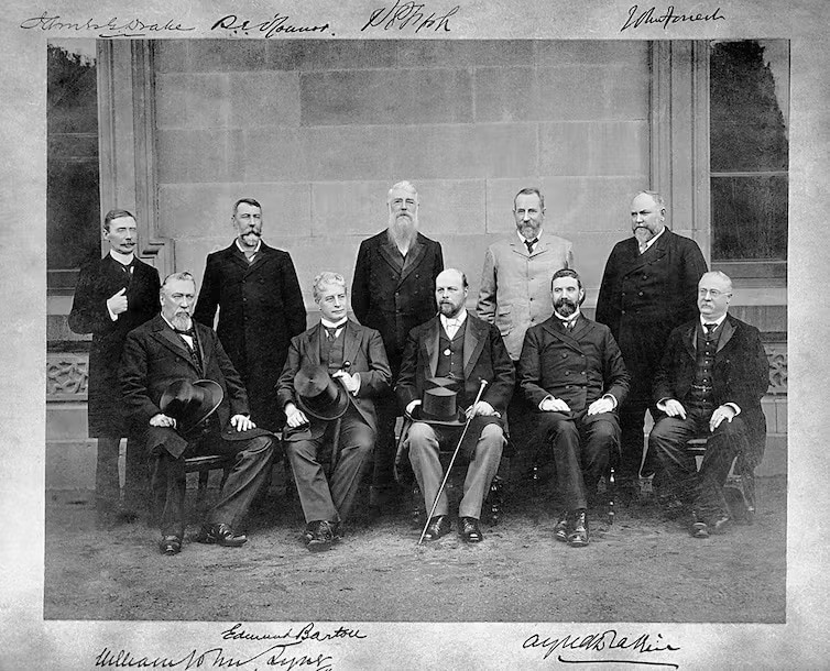 A black and white photos of a group of men in formal wear