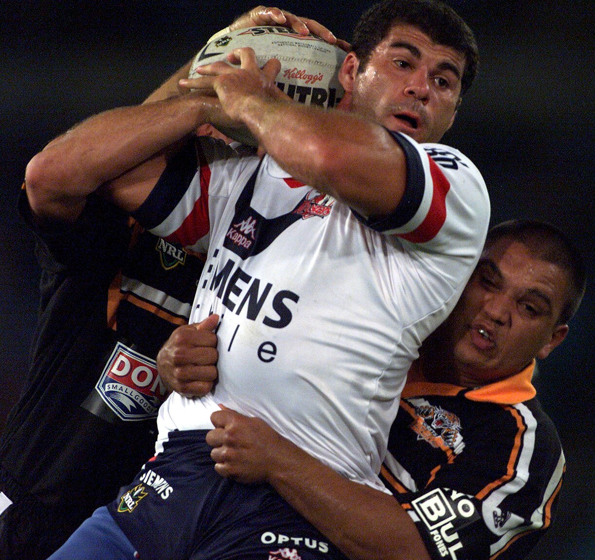 A man stands in the tackle during a rugby league match