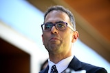 The NSW Treasurer Daniel Mookhey in a suit wearing glasses
