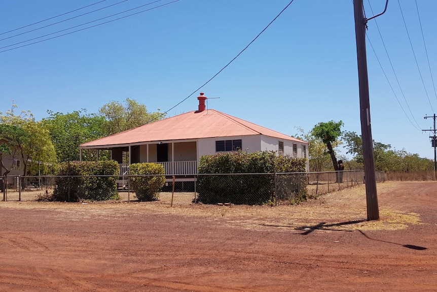 house and red dirt street