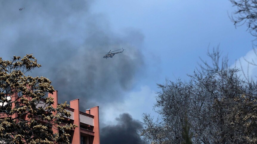 Afghanistan's Army helicopters fly above the hospital after the clash started.