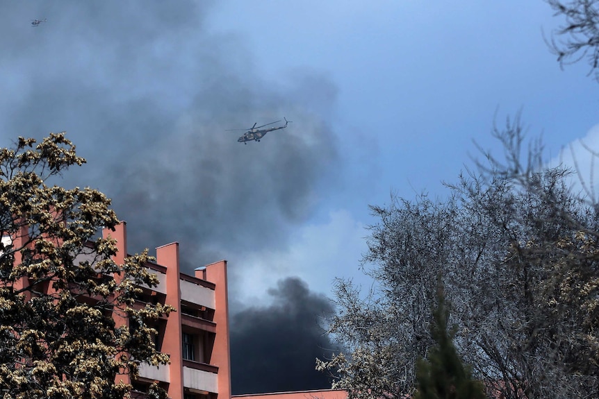 Afghanistan's Army helicopters fly above the hospital after the clash started.