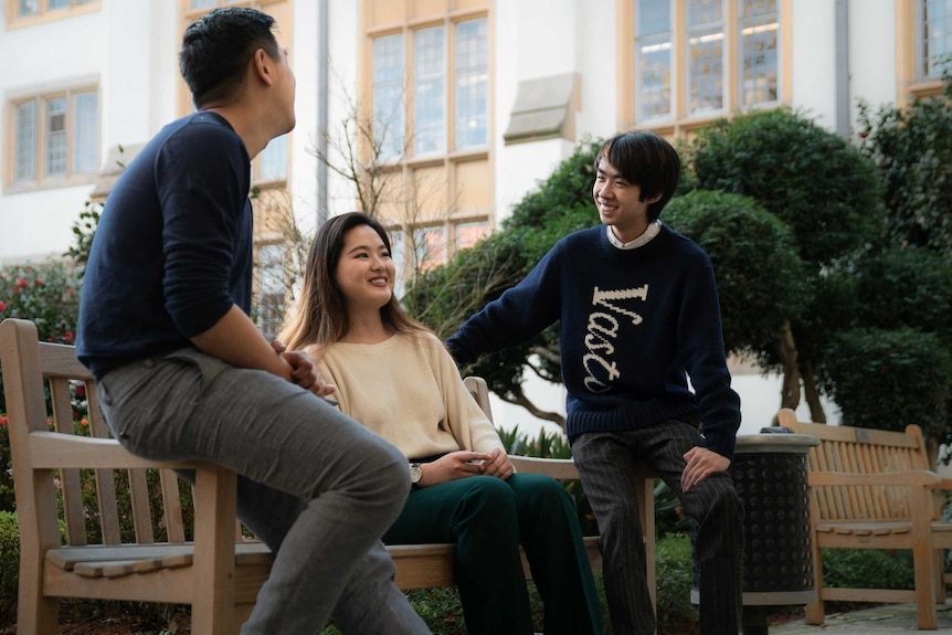 Clément Sun and his friend Abbey Shi talk in a courtyard in the University of Sydney.