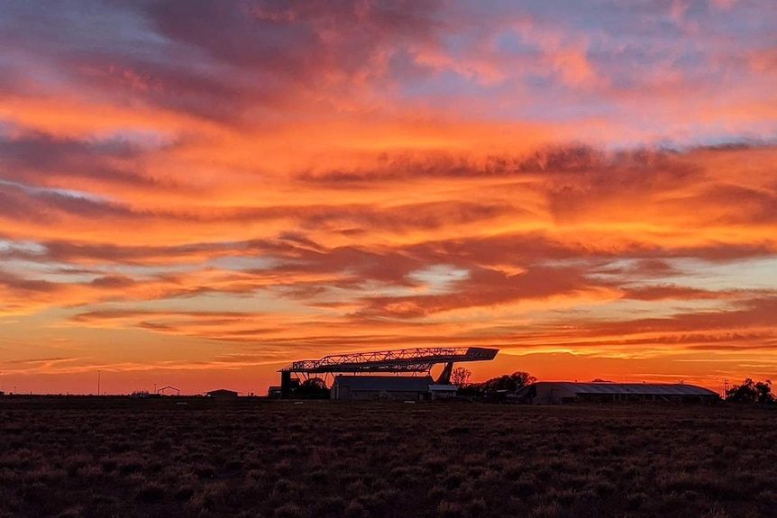 Sunrise at Longreach with the Qantas Founders Museum in silhouette.