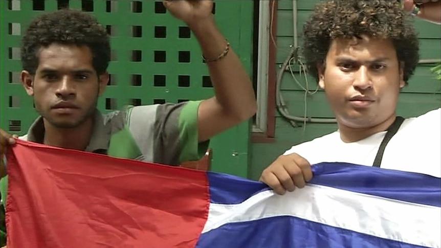 Two West Papuan activists hold the West Papuan flag in Port Moresby.