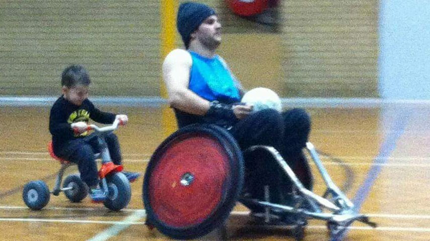 Australian wheelchair rugby player Jake Howe gets some quality time out on court with his young son.