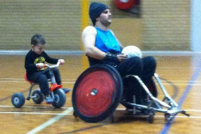 Australian wheelchair rugby player Jake Howe gets some quality time out on court with his young son.