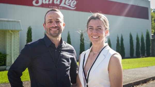 A man and woman stand outside the Sara Lee factory.