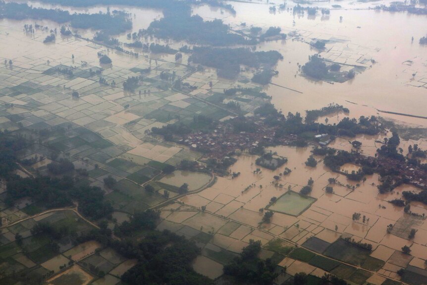 An aerial view of flooded land is seen at Dhanusha District. Much of the area is inundated with brown water.