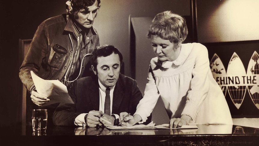 Staff assist a presenter before recording of a show back in the 60s.