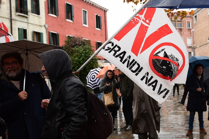 A protester holding a flag with the slogan No Grandi Navi
