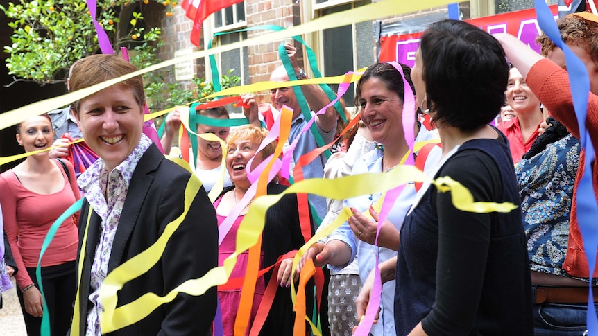 Sally McManus is showered in streamers by community workers