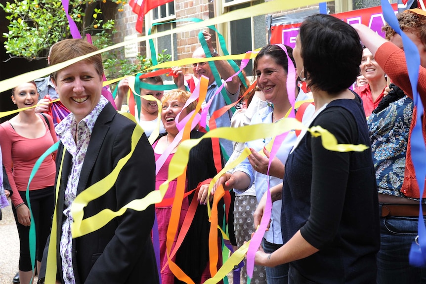 Sally McManus is showered in streamers by community workers