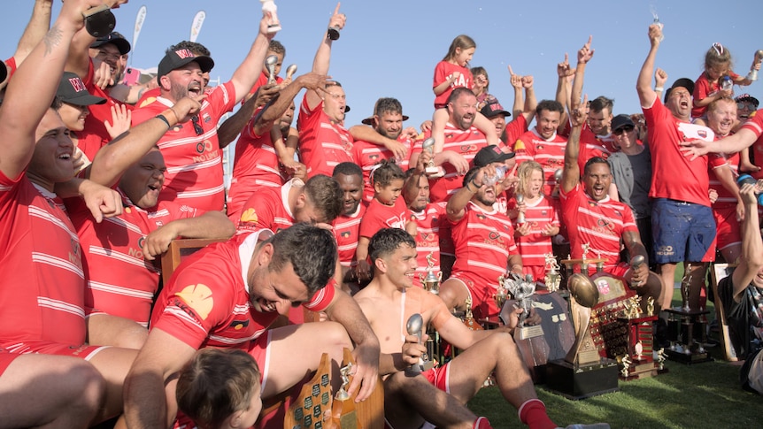 a rugby league team celebrate a win