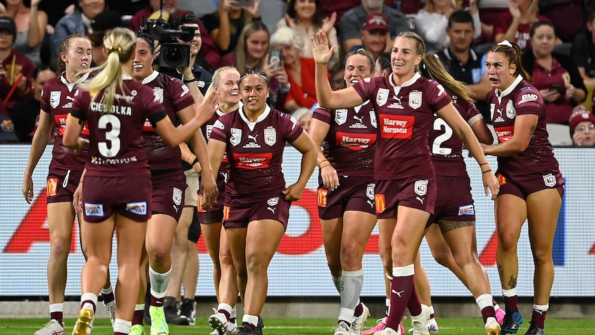 A rugby league team celebrates a try