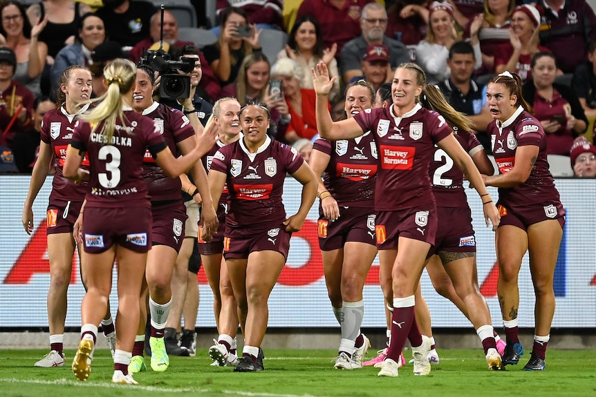 A rugby league team celebrates a try