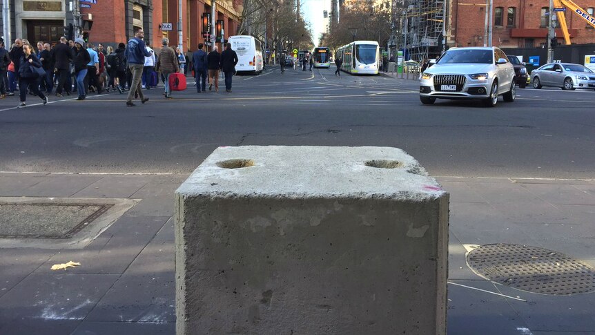 A concrete bollard outside Southern Cross Station, at the bottom end of  Bourke St.