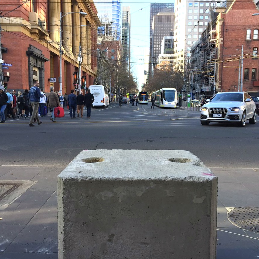 A concrete bollard outside Southern Cross Station, at the bottom end of  Bourke St.