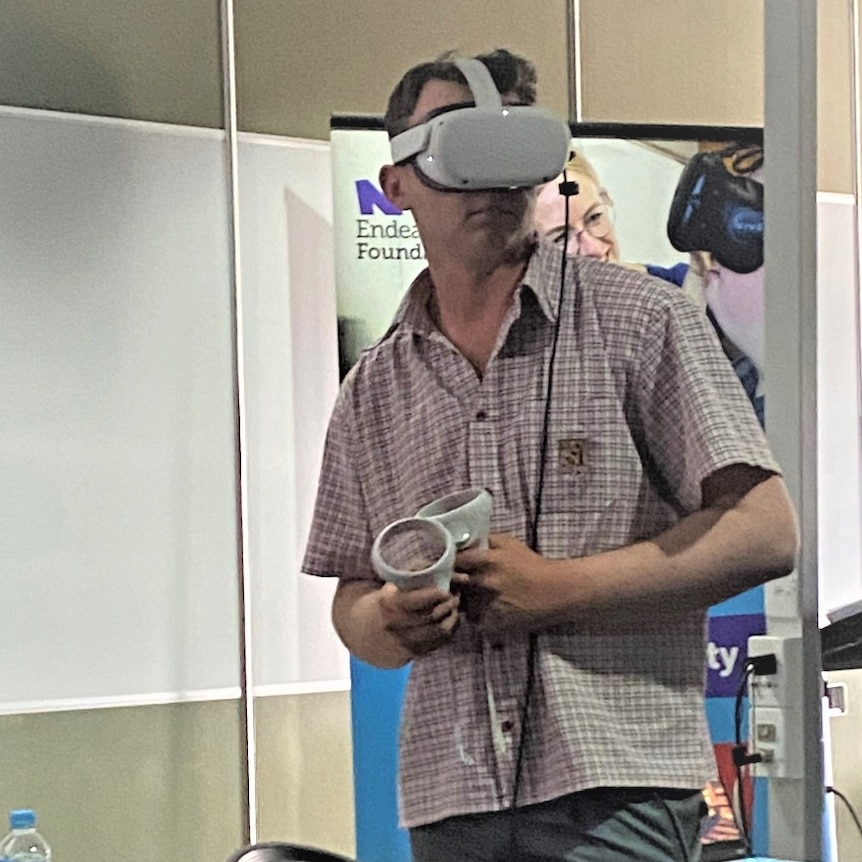 Student in a classroom wearing virtual reality goggles.