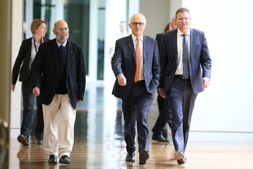 Malcolm Turnbull walking down a corridor