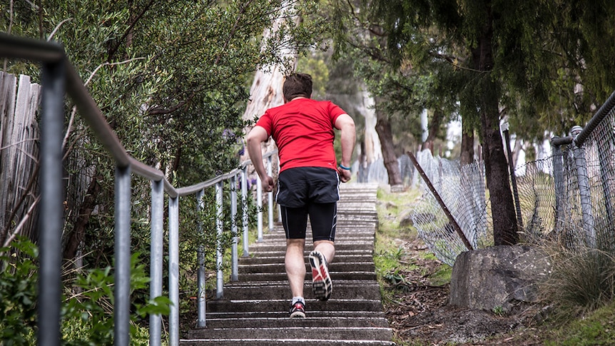 Man running up a set of very steep stairs