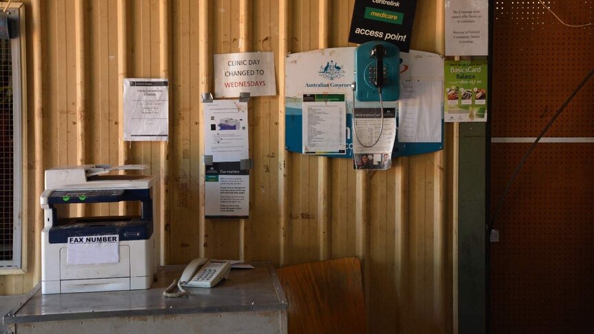 SA shed with a printer and some flyers taped to the wall.