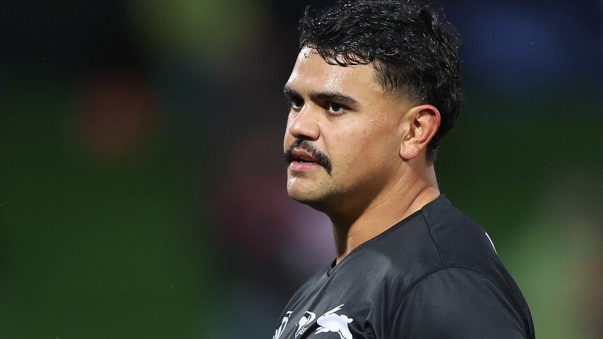 Latrell Mitchell looks to one side