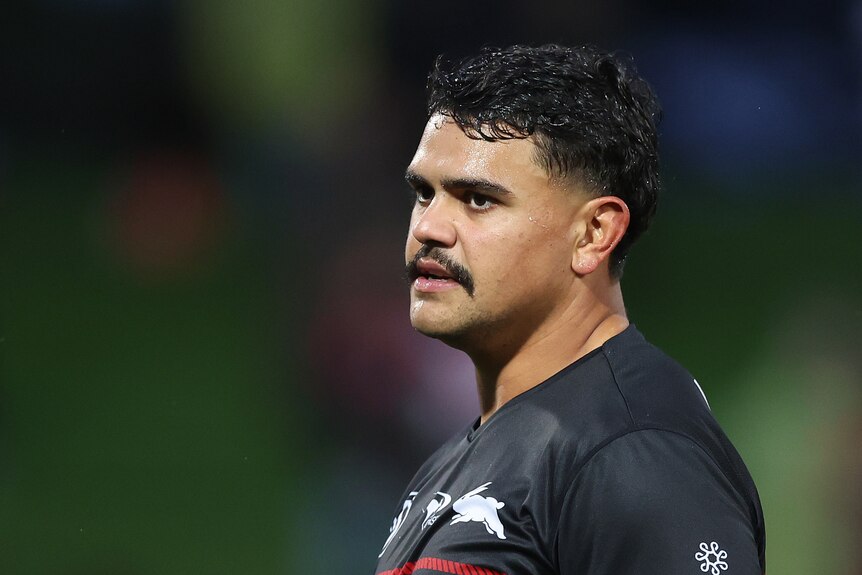 Latrell Mitchell looks to one side