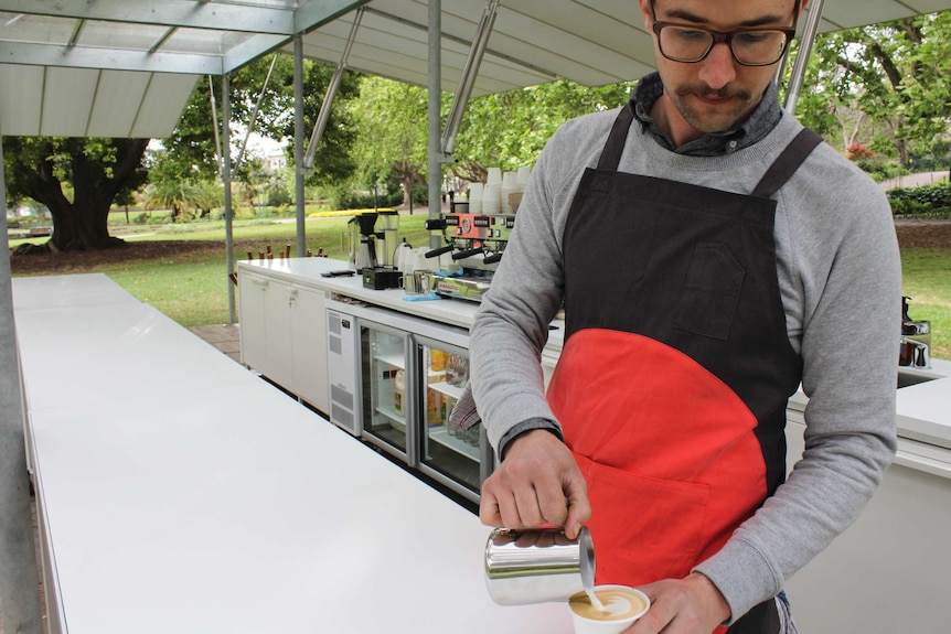 Barista pours coffee at MPavilion in Melbourne