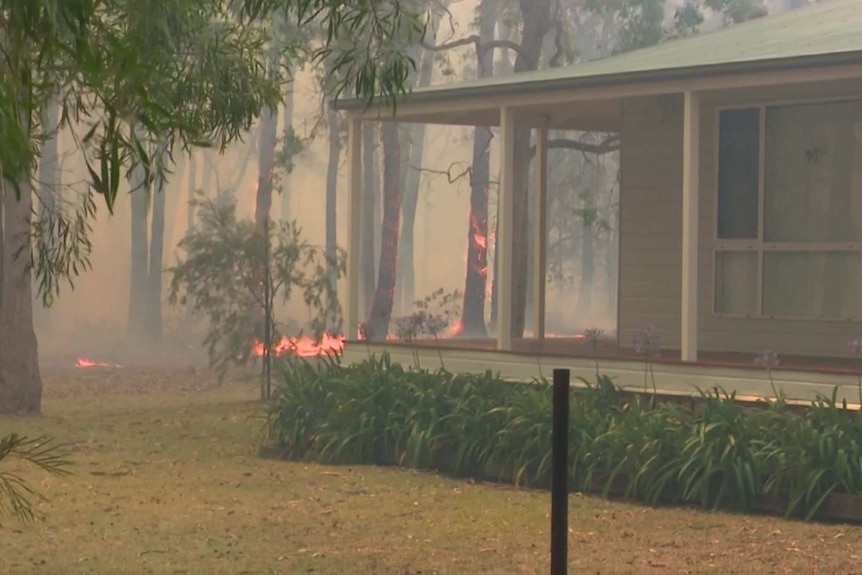 Fire burning near a home's verandah