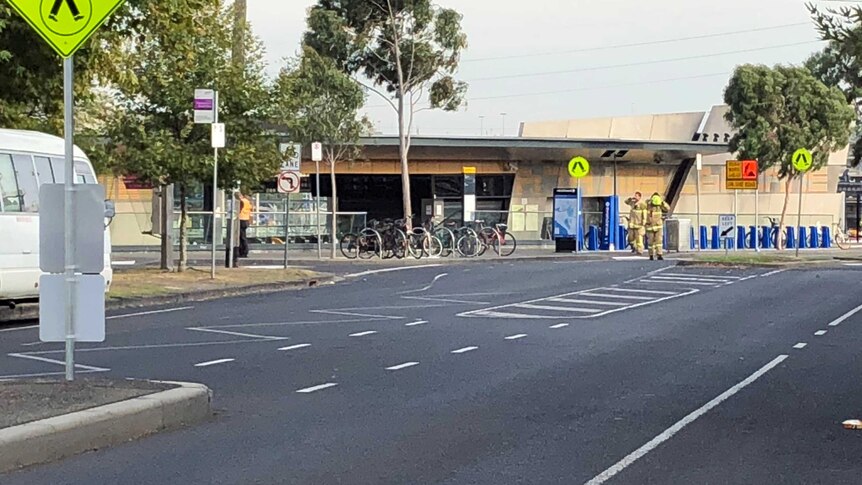 Fire officials and police tape outside North Melbourne train station during the evacuation.