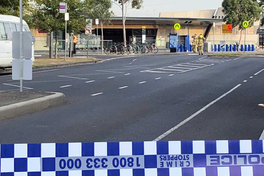 Fire officials and police tape outside North Melbourne train station during the evacuation.