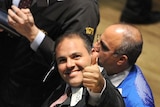 A trader gives a thumbs-up after the closing bell on the floor of the New York Stock Exchange