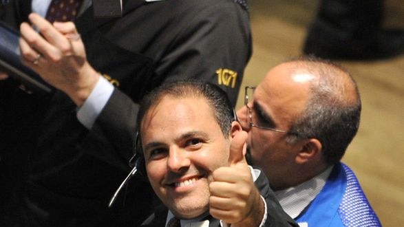 A trader gives a thumbs-up after the closing bell on the floor of the New York Stock Exchange