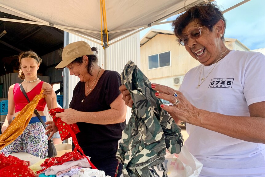 Women sort through donated clothes in Broome, January 2023.