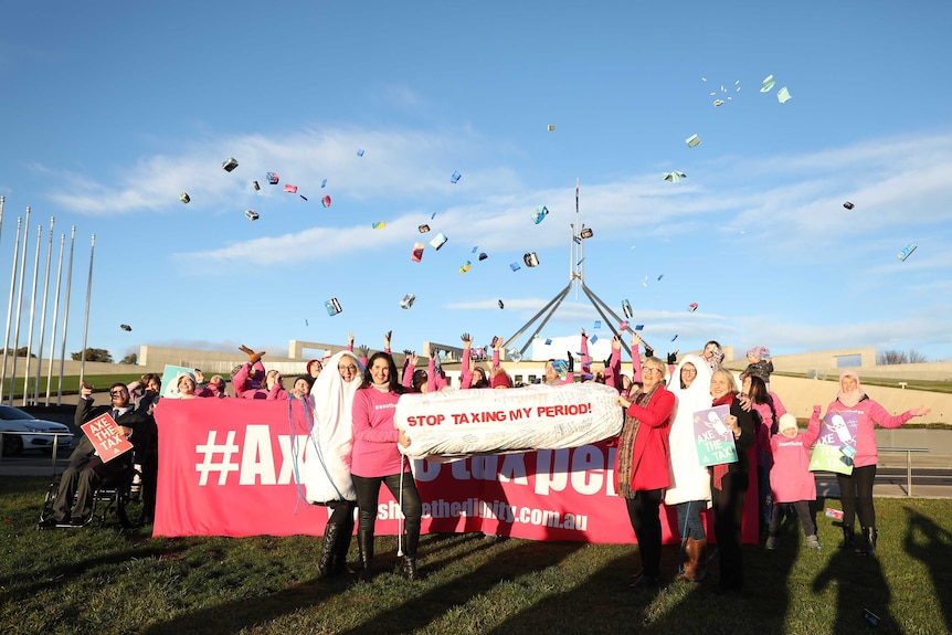 Greens Senators including Janet Rice, Lee Rhiannon and Jordon Steele-John join protestors with a "stop taxing my period" sign