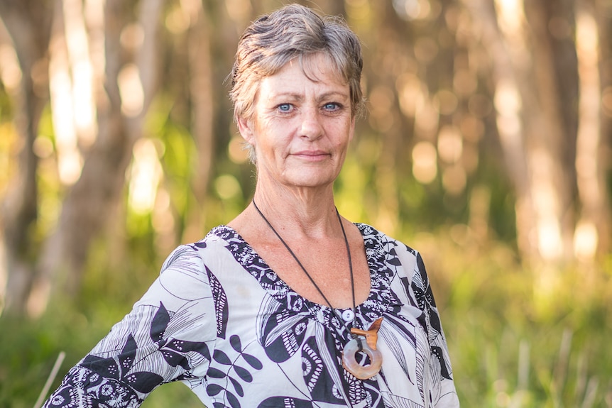 Rebecca Barnes standing in front of trees