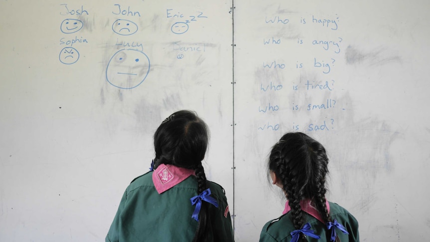 Thai girls standing in front of a white board