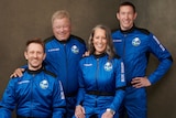 William Shatner and three other members of Blue Origin's second human spaceflight pose for a photo in astronaut gear.