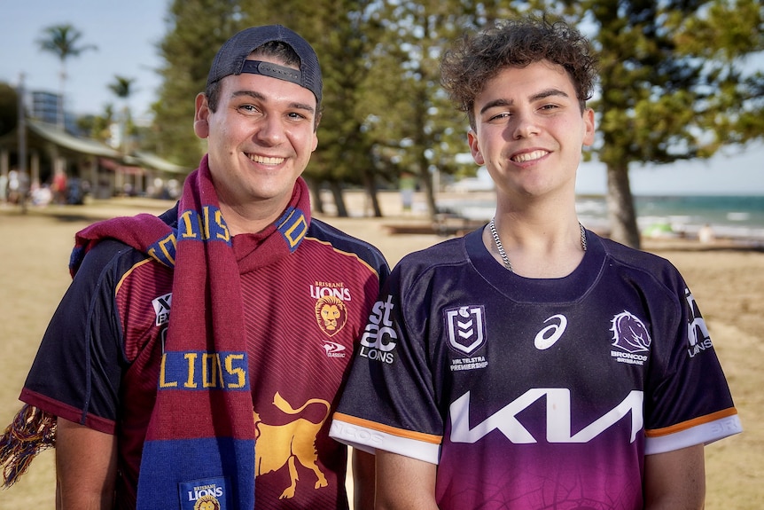 Two brothers wear Brisbane Lions and Brisbane Broncos merchandise