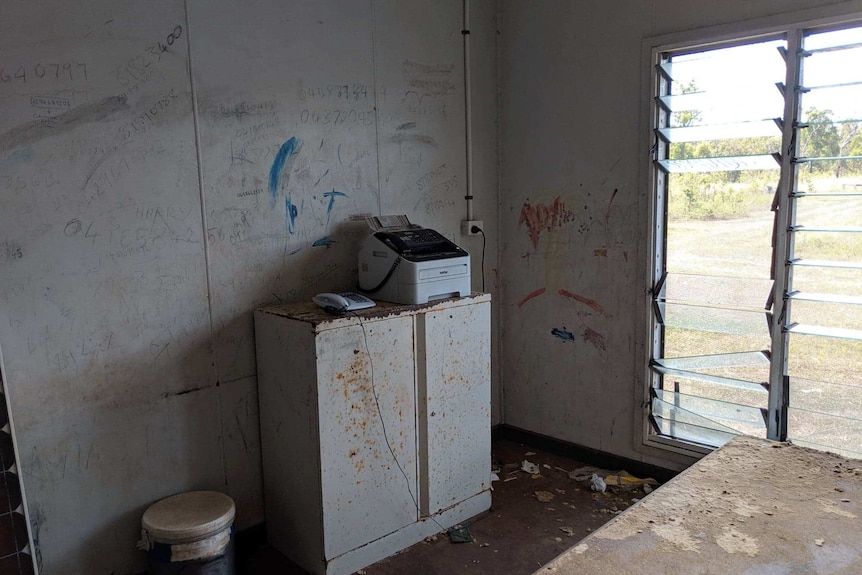 A graffiti stained wall in a classroom.