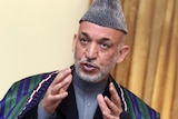 Afghan President Hamid Karzai gestures during a news conference