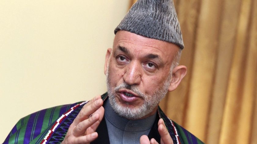 Afghan President Hamid Karzai gestures during a news conference