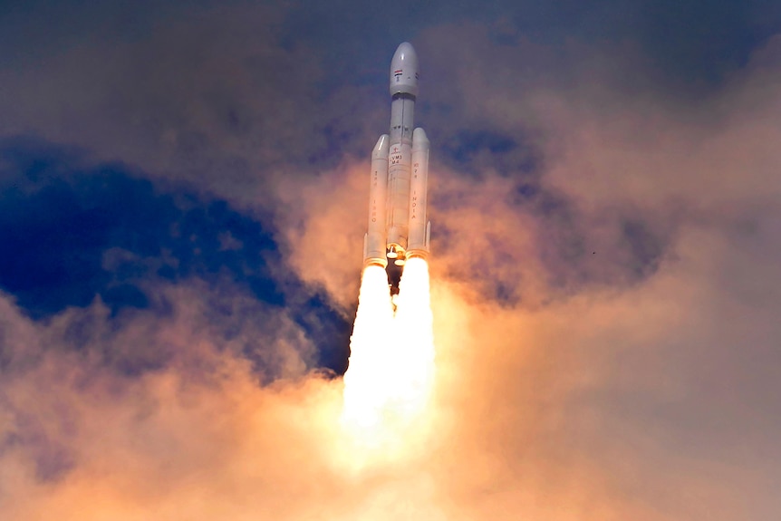 A large space craft rocketing through clouds in the sky, with flames coming from its engine exhausts