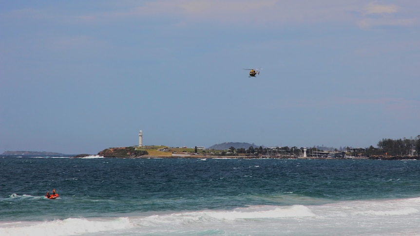 image of helicopter above wollongong coastline
