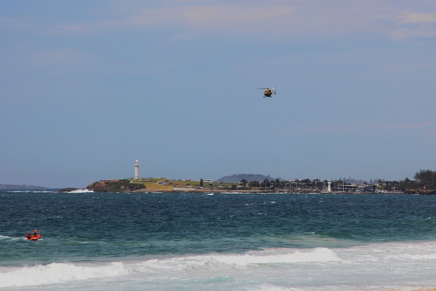image of helicopter above wollongong coastline