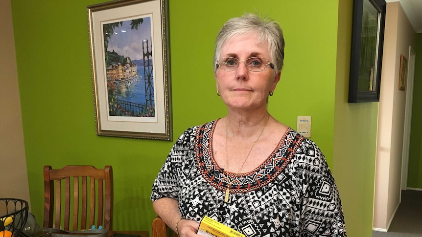 Vaginal mesh patient Jan Maessen holds medication as she discusses her chronic pain